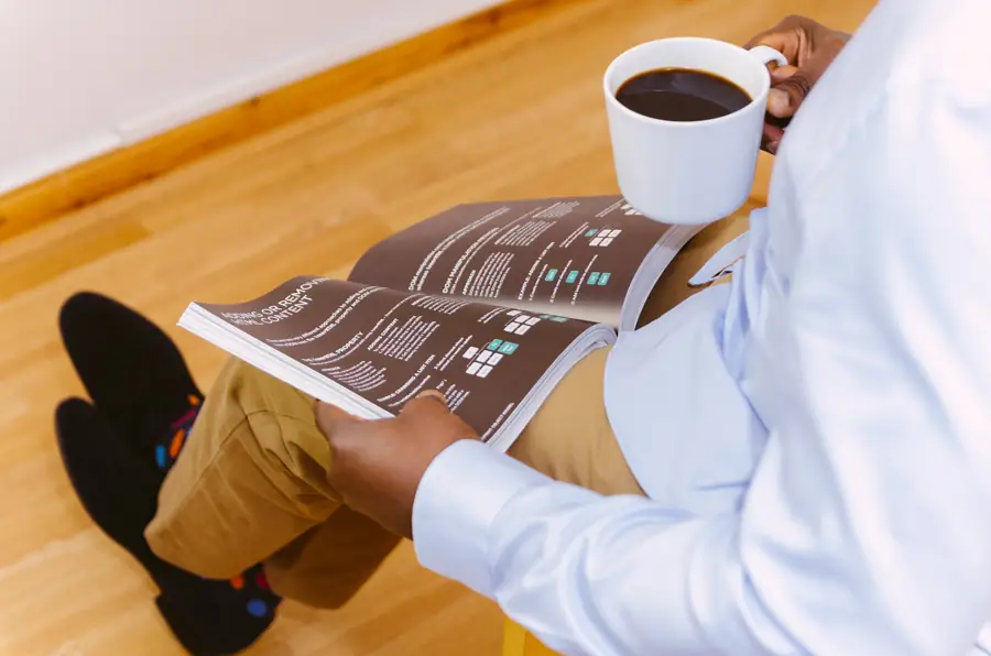 Business owner reading a report with a cup of coffee