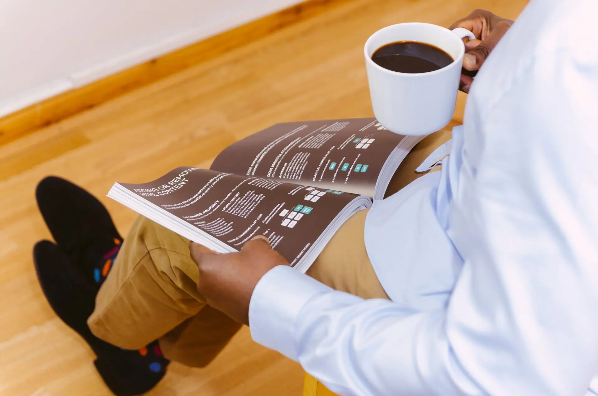 Business owner reading a report with a cup of coffee