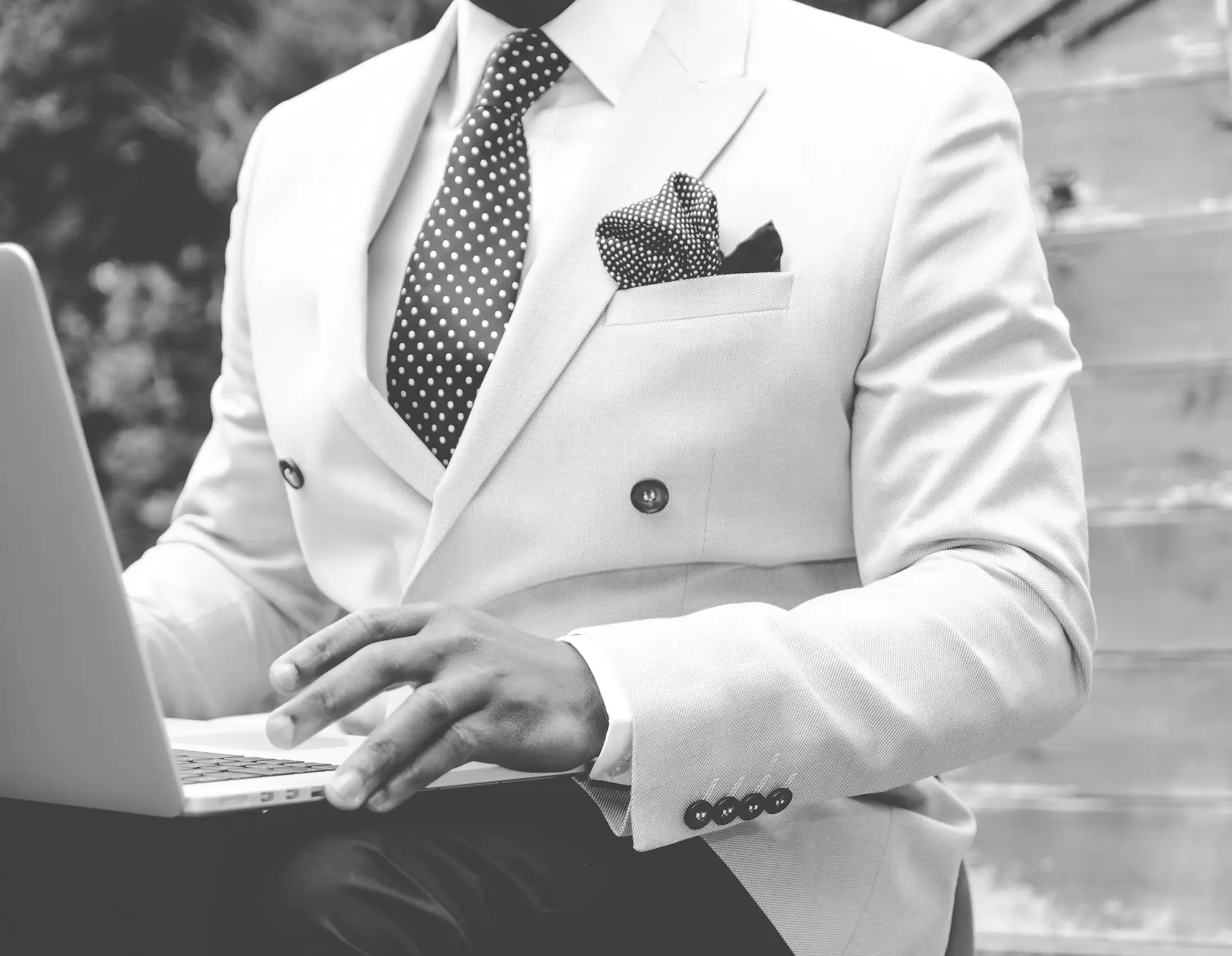 Professional in a suit working on a laptop